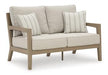 Hallow Creek Outdoor Loveseat with Cushion - BWO Furniture & Mattresses